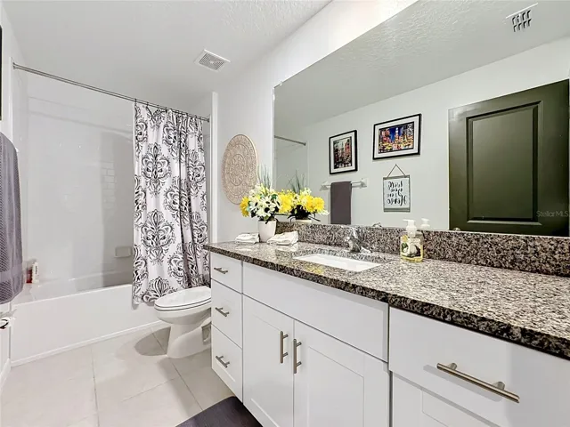 Bathroom 2 with granite vanity and tub/shower combination
