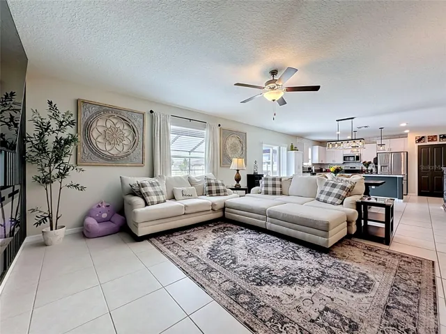 Spacious living room with custom accent wall and electric fireplace