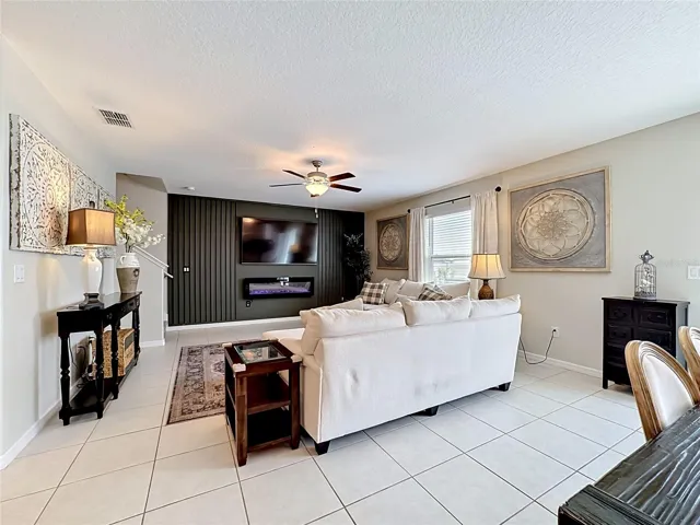 Spacious living room with custom accent wall and electric fireplace