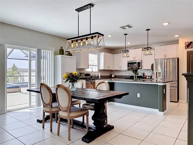 Beautiful kitchen and dining area with updated lighting and modern finishes