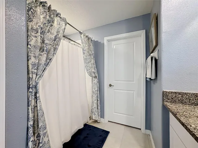 Primary en-suite bathroom with dual sink vanity and step-in shower