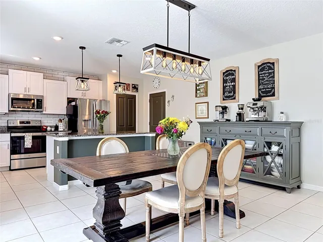 Beautiful kitchen and dining area with updated lighting and modern finishes