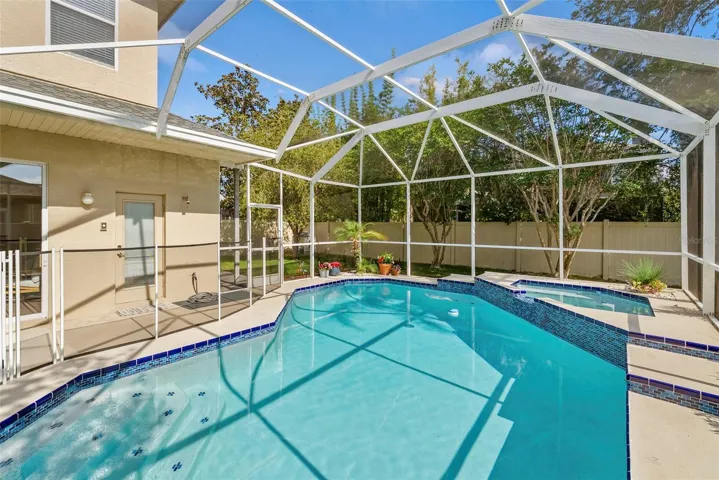 Heated pool and spa with safety fence.