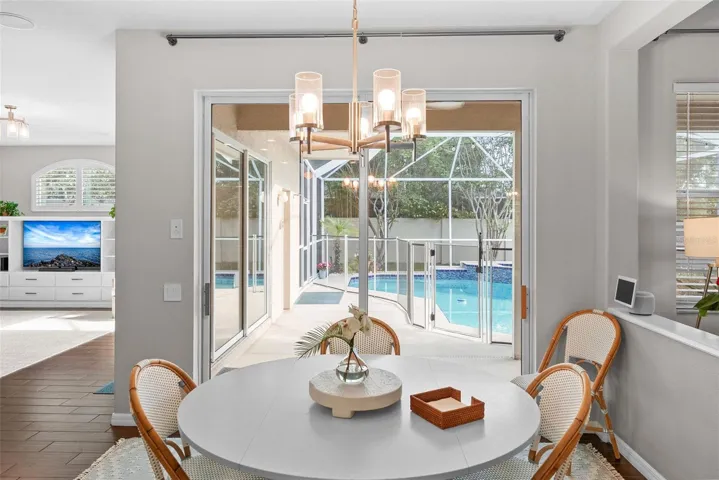 Dinette off of the kitchen overlooking the pool oasis.