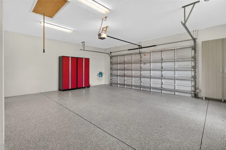 SPACIOUS 2 CAR + 2 GOLF CART GARAGE. PULL DOWN ATTIC STAIRS, WATER FILTRATION SYSTEM, AND NEWLY COATED EPOXY FLOORING.