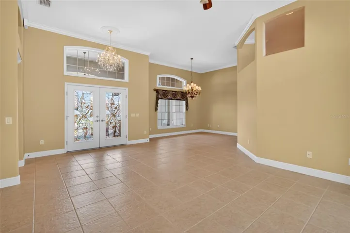 DINING ROOM TO THE RIGHT WITH LARGE WINDOW AND TRANSOM.