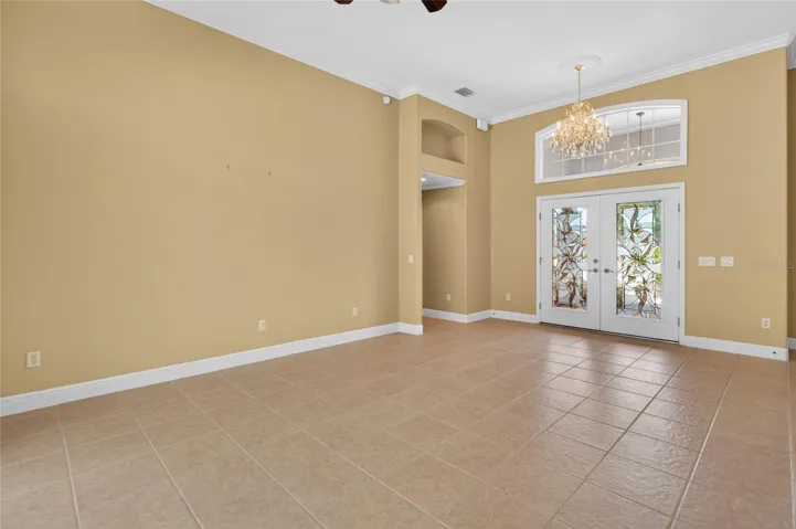 LOVELY ENTRANCE WITH LEADED GLASS FRONT DOORS AND LARGE TRANSOM. TILE THROUGHOUT THE FOYER, LIVING, AND DINING ROOM.