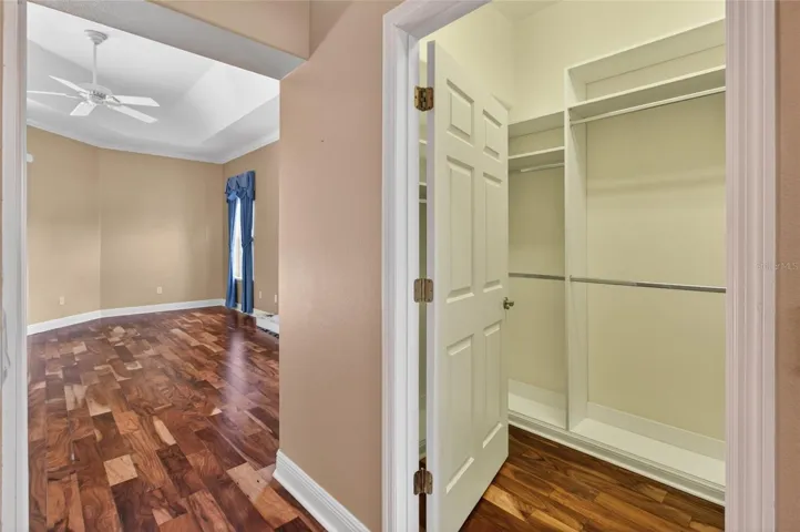 THERE ARE 2 CLOSETS WITH BUILT-INS IN THE HALLWAY LEADING FROM THE PRIMARY BEDROOM TO THE PRIVATE BATH.