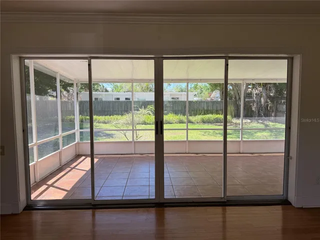Living room looking through lanai and into back yard