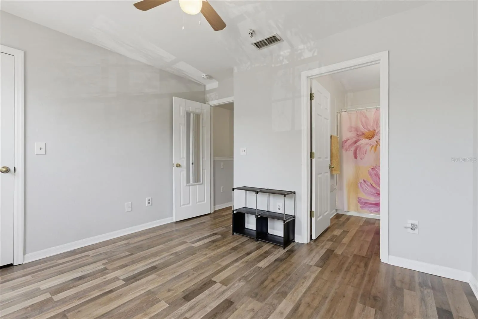 View of guest bedroom door and bathroom entrance