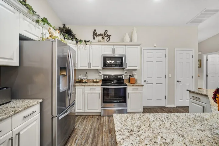 White cabinets with Crown molding and Stainless appliances set off the gleaming granite counters