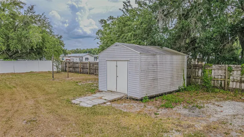 Large shed in the backyard for storage and lawn equipment