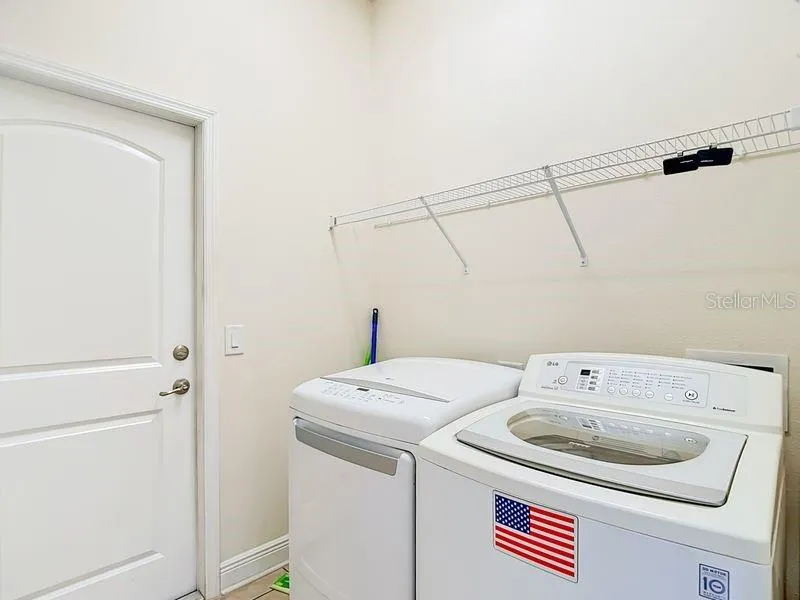 Convenient laundry room located just off kitchen- this space also offers easy access to garage for added functionality
