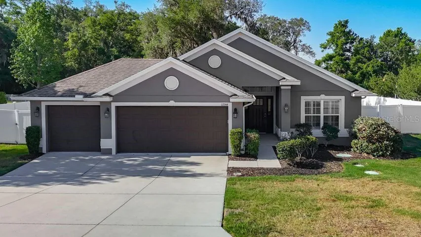 Single-story residence offering timeless curb appeal with its modern gray exterior, crisp white trim, and inviting entryway