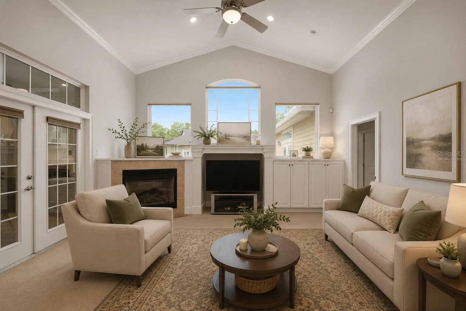 Large family room with access to sunroom, virtually staged