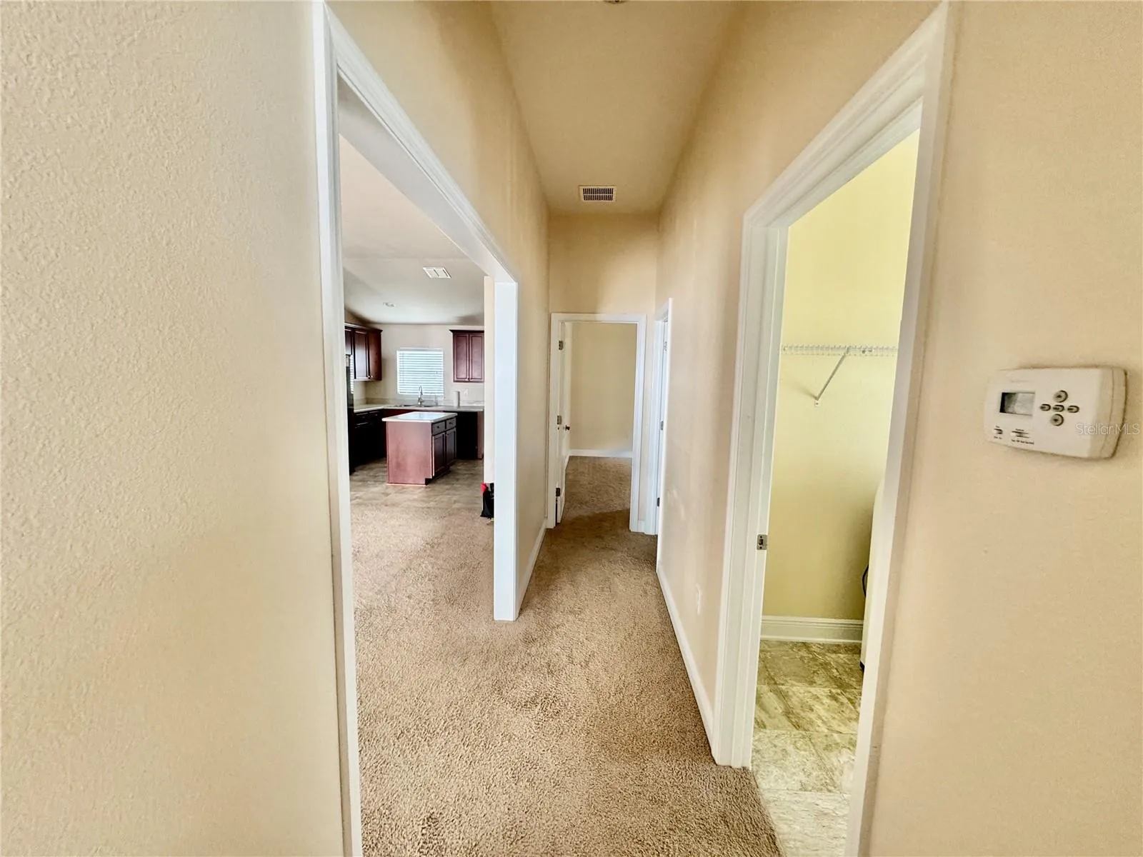 HALLWAY BETWEEN GUEST BEDROOMS, BATH, AND LAUNDRY ROOM