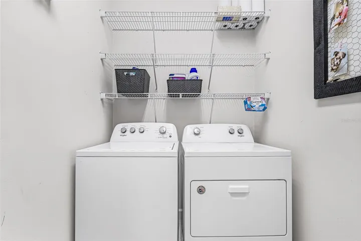 Indoor laundry room with shelves for storage