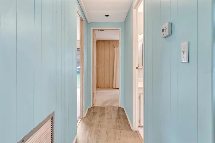 Main Hallway to guest bathroom on Right, Bedroom 2 straight ahead and Primary Bedroom on Left