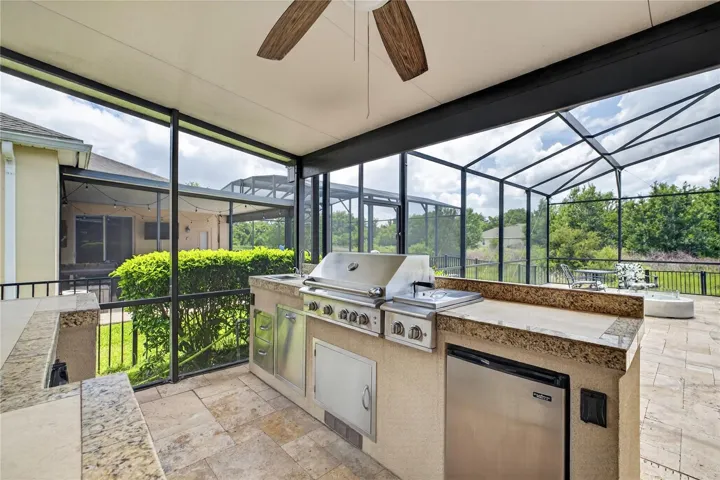 Full summer kitchen with 2 bar fridges and built in speakers and more