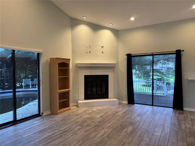 family room with fire place and pool and porch doors