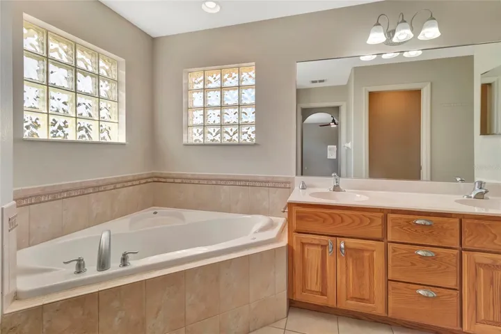 Dual sinks and Jacuzzi Tub inside Primary 1 Bathroom