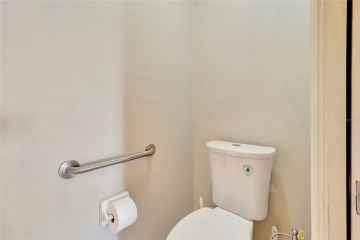Toilet with pocket door for privacy inside Primary 2 Bathroom
