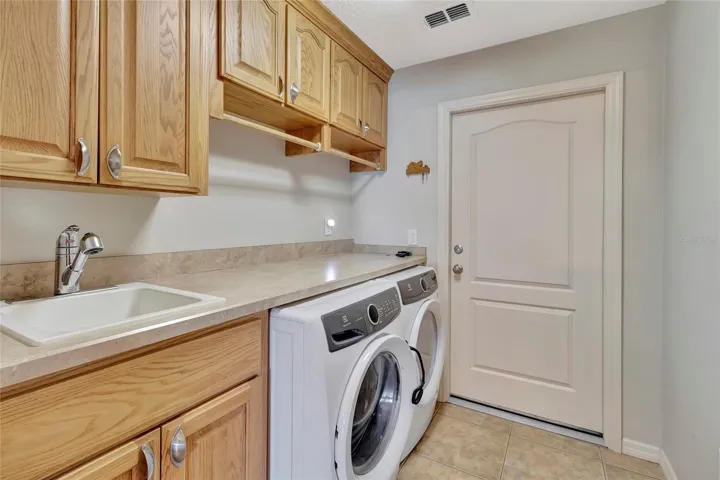 Inside Laundry Room with a pocket door to close off from Kitchen/Living Room. Door in picture is to the Garage.