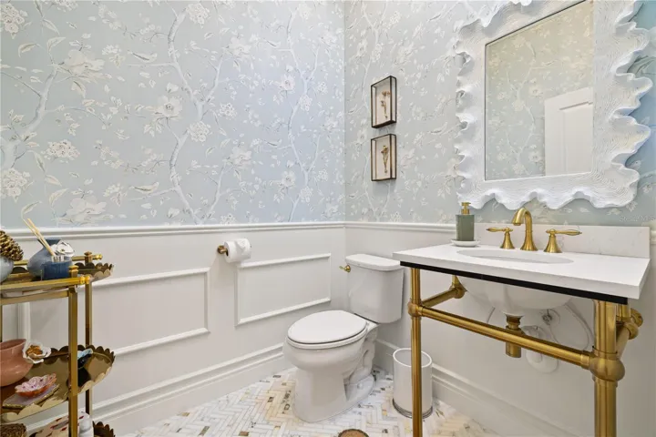 1/2 bathroom with boiserie and wall paper.