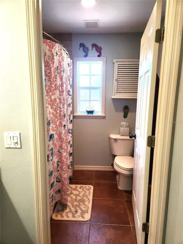 Primary with tub/shower combination and separate vanity area.