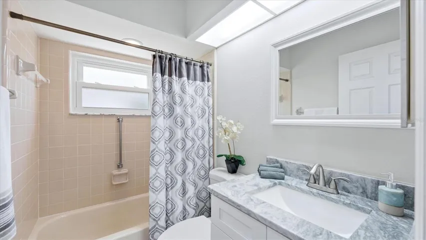 THE SECOND BATHROOM HAS TALL VANITY AND GRANITE COUNTERTOP WITH TUB AND SHOWER COMBINATION