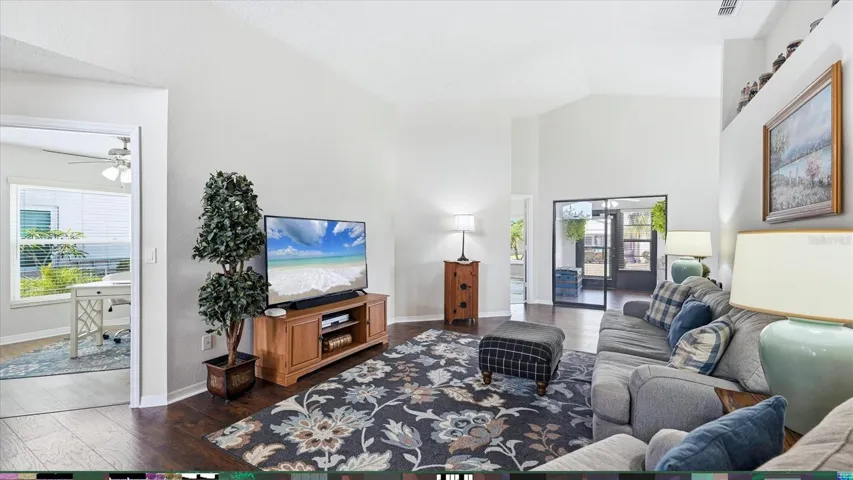 FROM THE DINNING ROOM INTO LIVING ROOM, DEN, FLORIDA ROOM