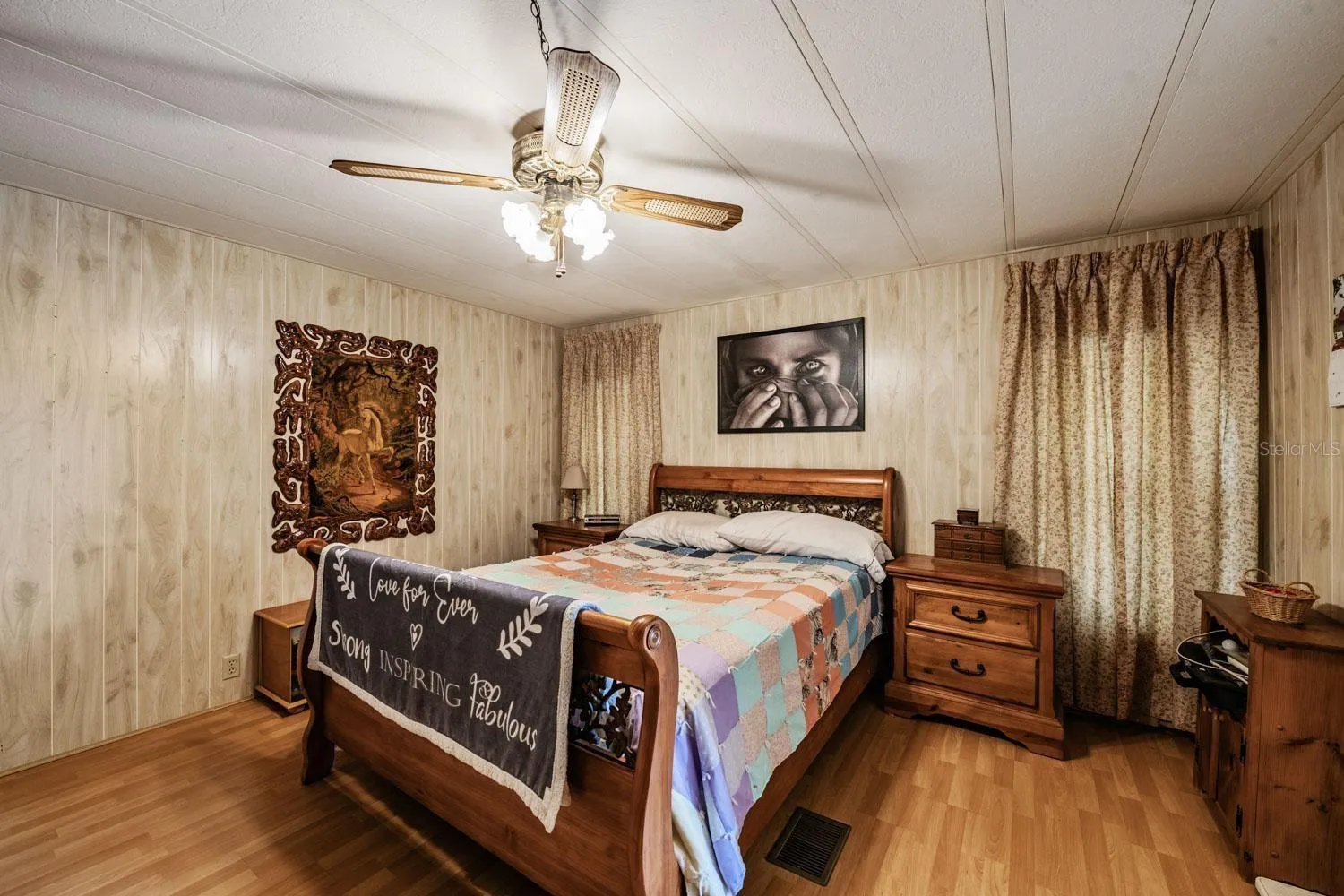 Primary bedroom has walk-in closet, ceiling fan, and laminate flooring.