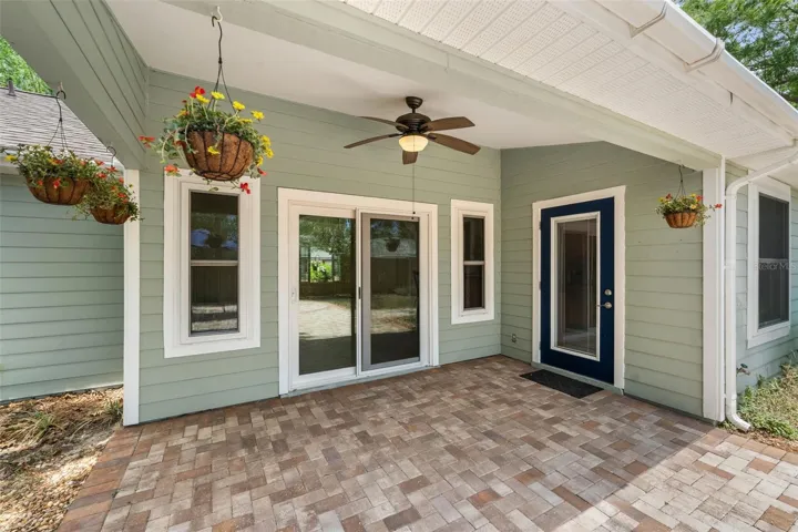 Covered, back paver patio with access from slider (with screen option) or French door with built in blinds
