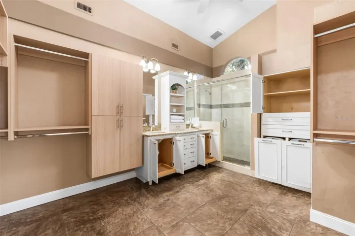 Slide out cabinetry inserts for functional storage + hamper drawers in towel storage cabinet