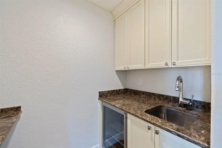 Owner's bedroom with a kitchenette for morning coffee or an evening glass of wine. The opposite wall accommodates a desk or a space for any other display or storage need.