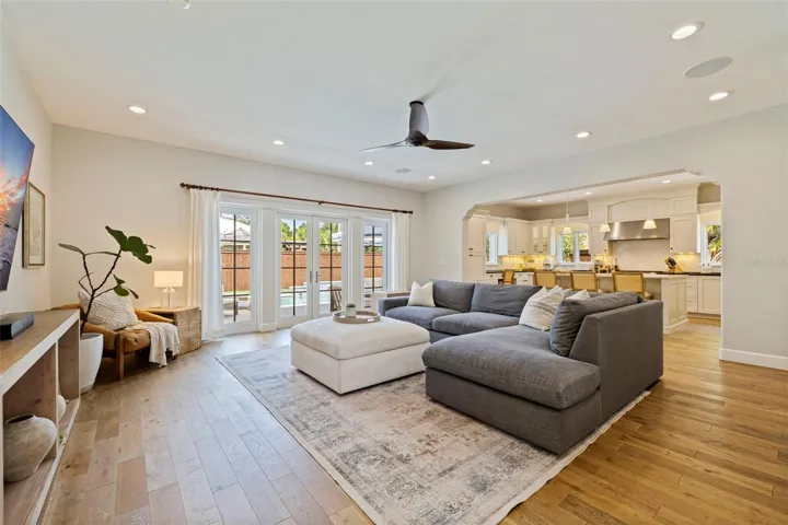 Open and spacious living room that opens up to the kitchen, courtyard, mud room and garage, and the backyard.