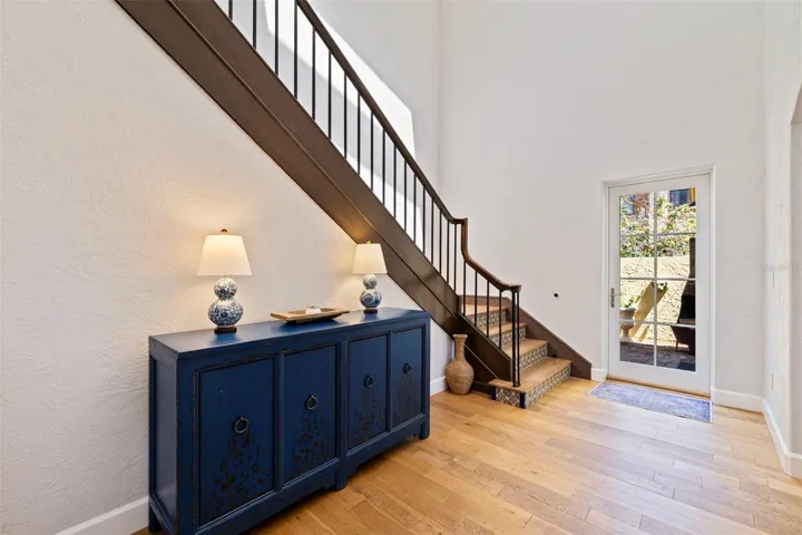 Grand stairs to the bedrooms. The door goes out to the outdoor dining are and the executive office.