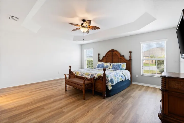 Primary bedroom, luxury plank floor and tray ceiling