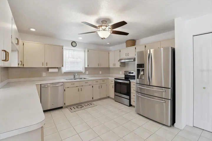Kitchen w/ Stainless Steel Appliances, Tiled Backsplash, Pass Thru Window to the Dining Room & Pantry