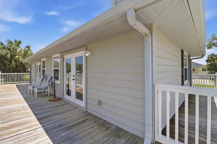 Double French Doors Lead to the Upper Level Wrap Around Wood Deck