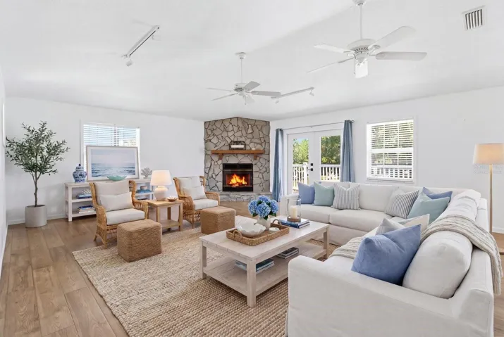 Virtually Staged... Living Room w/ PERGO Laminate Flooring, French Doors to the Upper Level Deck & PreFab Wood Burning Fireplace w/ Stone Veneer Surround, Cedar Mantle & Prewiring for Blower