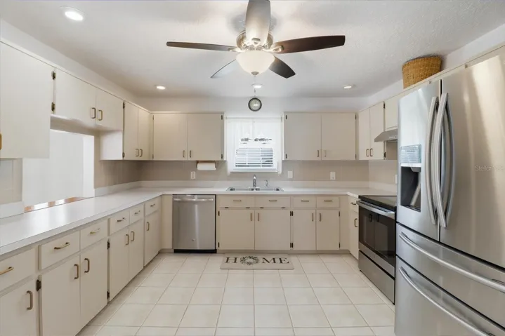 Kitchen w/ Stainless Steel Appliances, Tiled Backsplash & Pantry