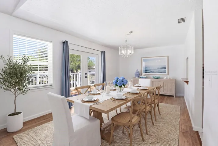 Virtually Staged... Dining Room w/ PERGO Laminate Flooring & French Doors to the Upper Level Wrap Around Wood Deck