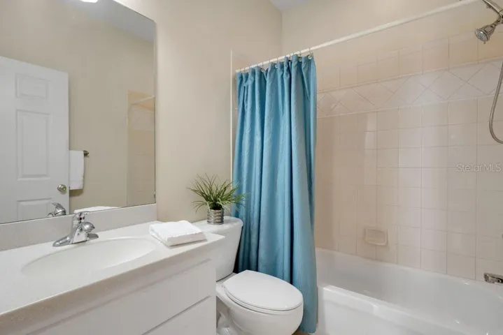 is situated directly across the hall from the second bathroom.