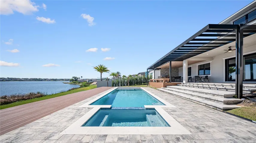 Stunning lakefront pool and spa with expansive sun deck