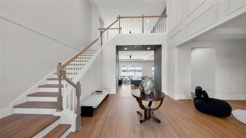 Grand two-story foyer with custom staircase and open loft overlook