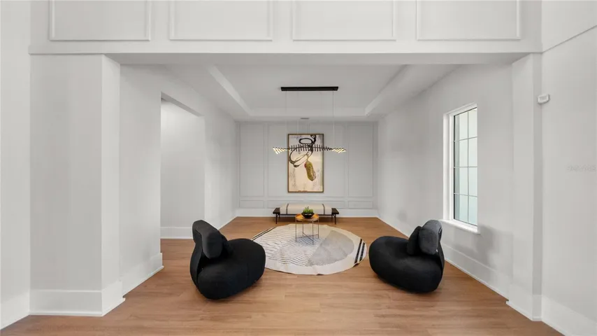 Formal sitting area or formal dinning,  with soaring ceilings and designer feature wall
