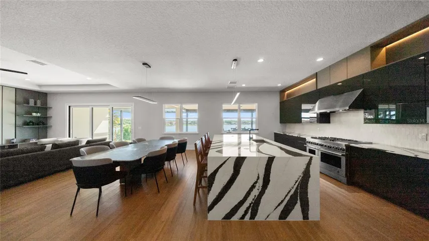 Gourmet chef’s kitchen Cambria Bentley quartz waterfall island custom cabinetry.