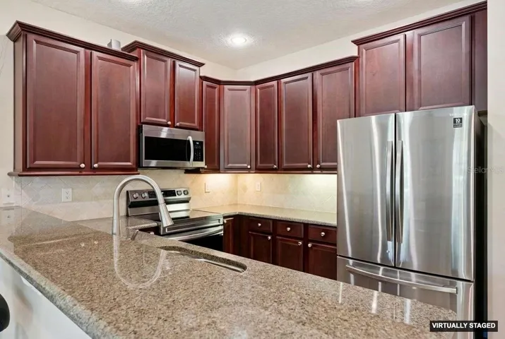 Updated kitchen with stainless steel appliances, granite counters & 42
