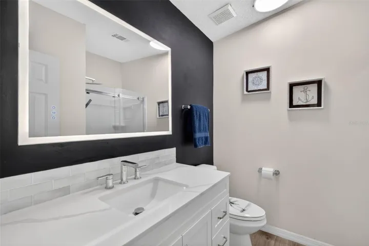 Updated primary bath with lighted mirror